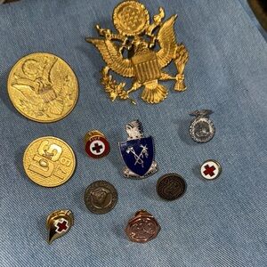 Collection of Military and Red Cross Pins on Denim
